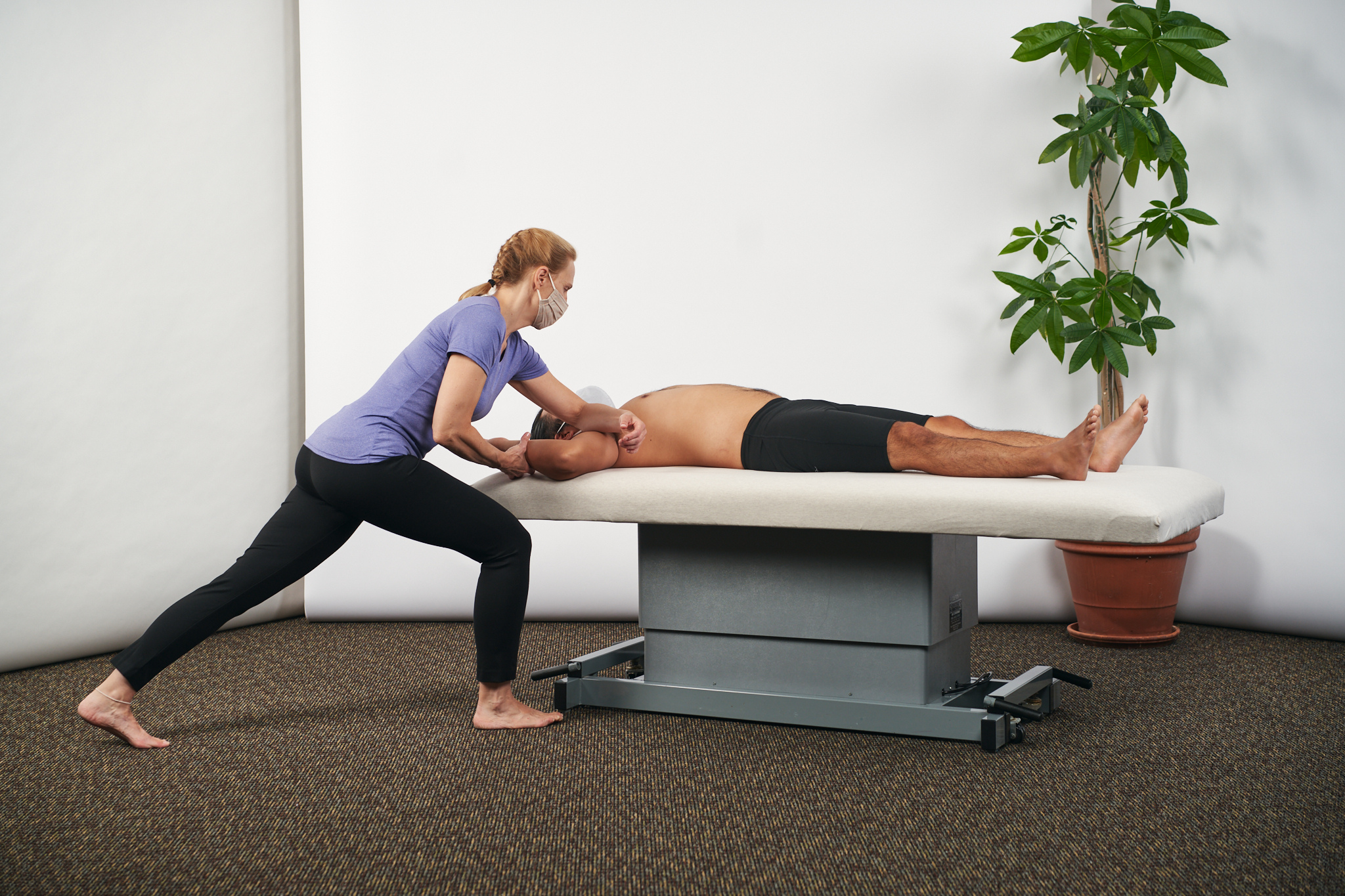woman giving man rolfing treatment