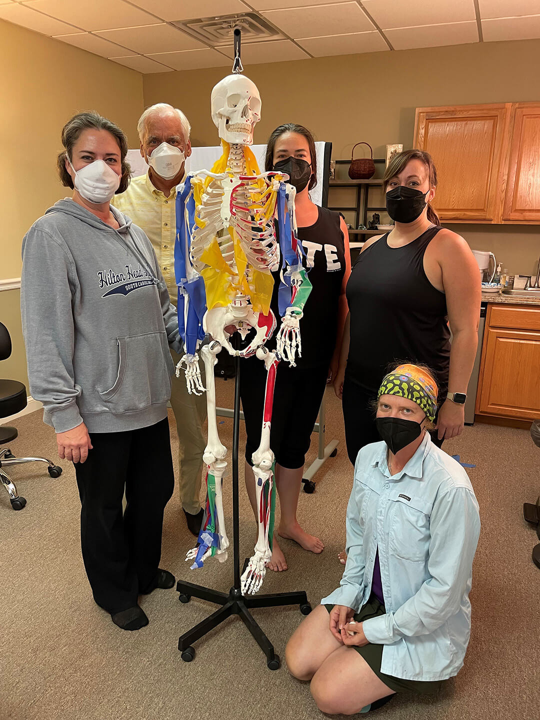 Rolfing Structural Integration students at the Dr. Ida Rolf Institute, taking a break with the model skeleton, during the anatomical review portion of the accredited course to become certified Rolfers.